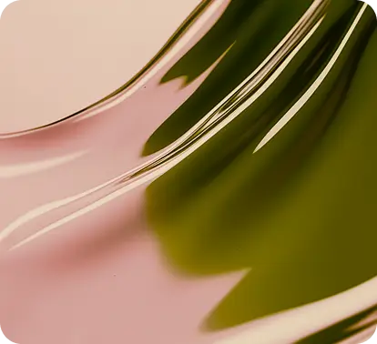 Close-up of a smooth, curved surface with reflective pink and green hues.